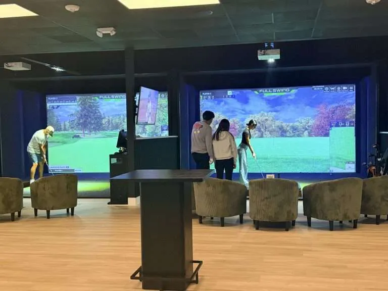 Two Full Swing simulator bays in use at Golfer's Den